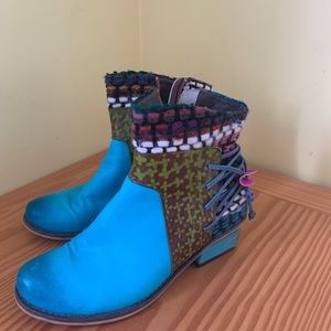 Unique blue leather boot with fabric detail.